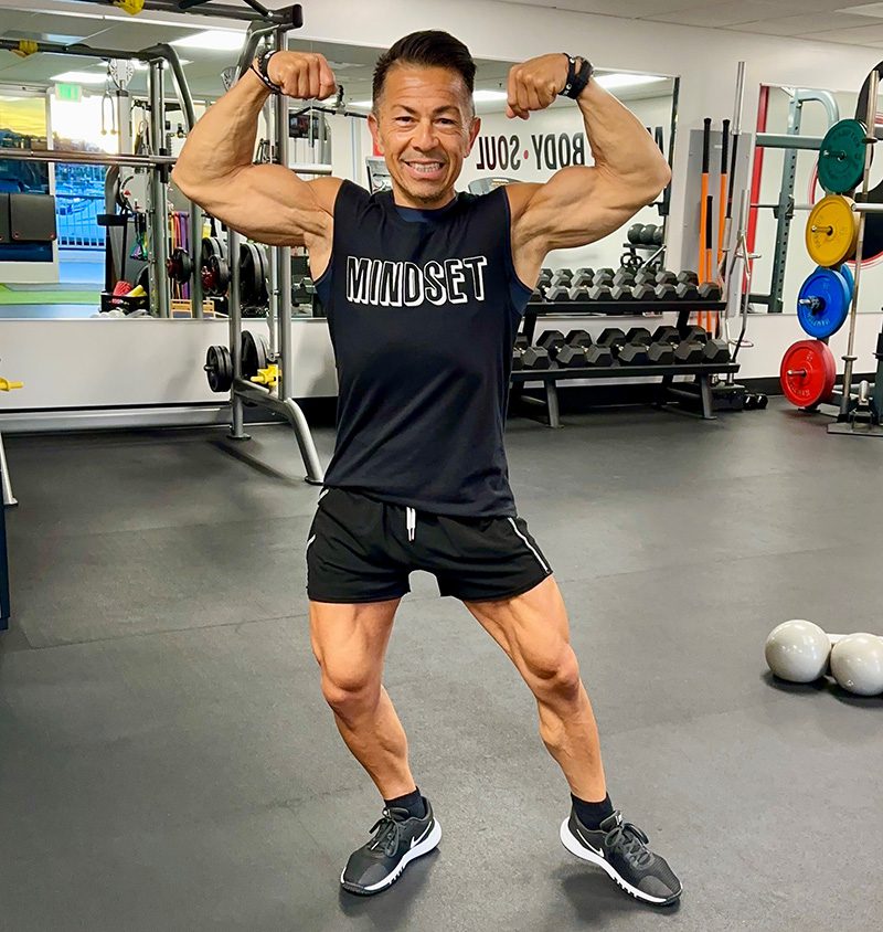 Nicandro flexing muscles Mindset Fitness 2 Smiled attractive girl mulatto with centimeter tape on the waist